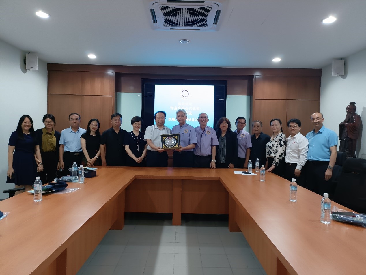 教总主席谢立意（右八）赠送纪念品予河南省海外联谊会副会长李凯（右九）。